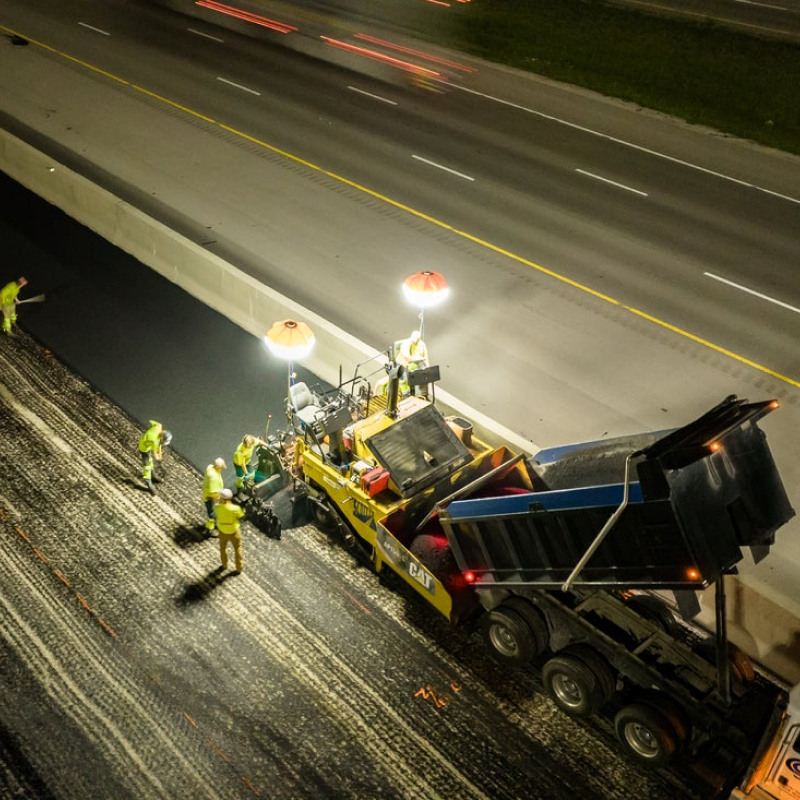 construction worker paving road